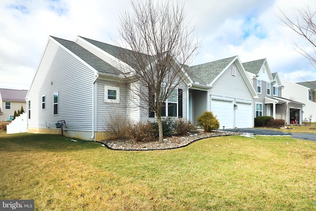 view of front of home with a garage and a front lawn