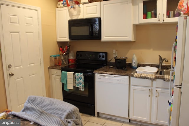 kitchen with white cabinetry, light tile patterned flooring, and black appliances