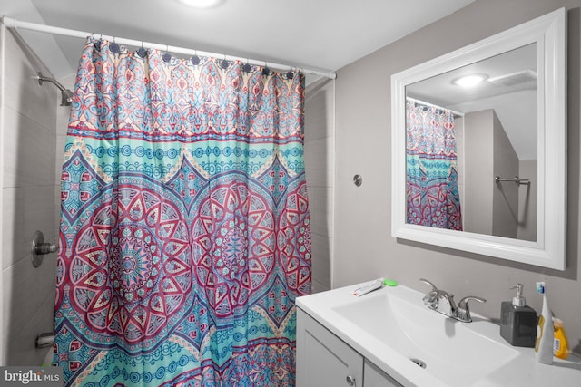 bathroom featuring vanity and a shower with shower curtain