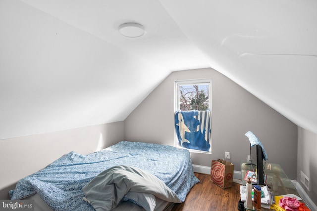 bedroom with wood-type flooring and vaulted ceiling