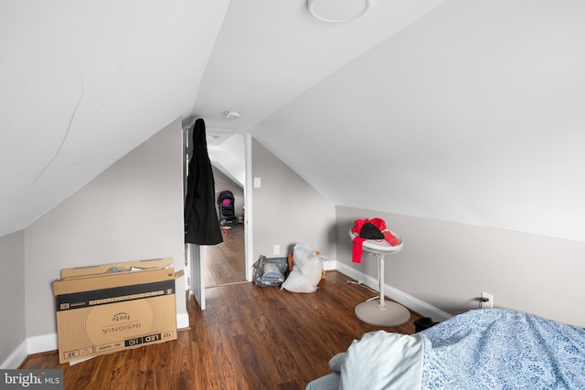 bonus room with dark wood-type flooring and lofted ceiling