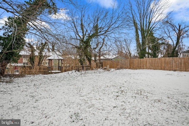 snowy yard featuring a gazebo