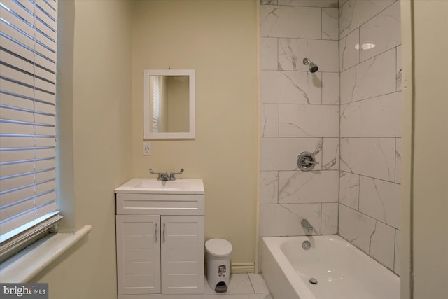 bathroom with tiled shower / bath combo and vanity