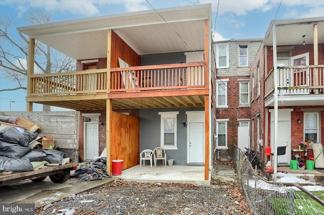 rear view of property with a balcony and a patio area