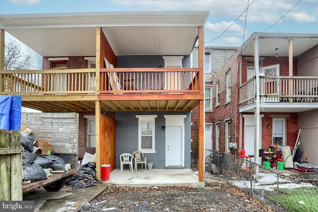 back of house featuring a balcony