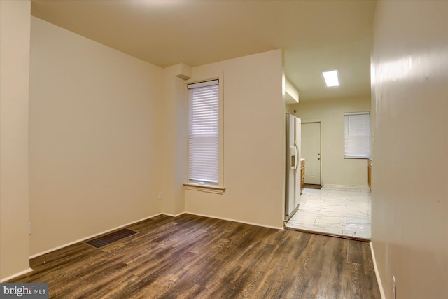 unfurnished room with wood-type flooring