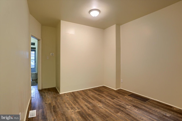 spare room with dark hardwood / wood-style flooring