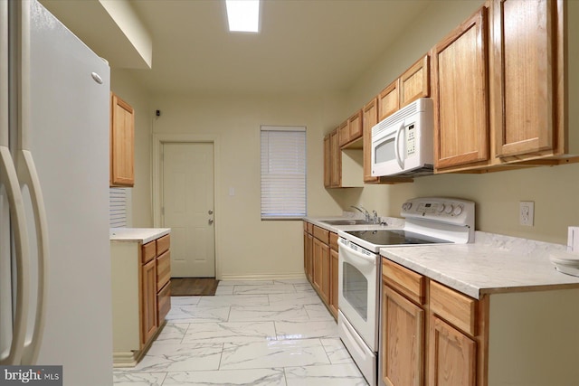 kitchen featuring white appliances and sink