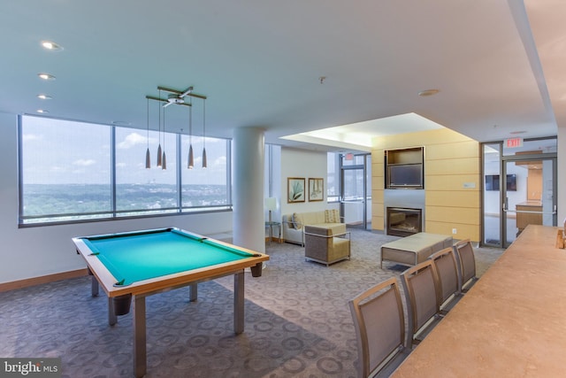 rec room with a water view, carpet flooring, pool table, and a fireplace