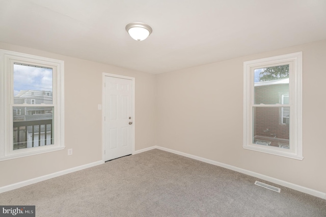 unfurnished room with carpet flooring