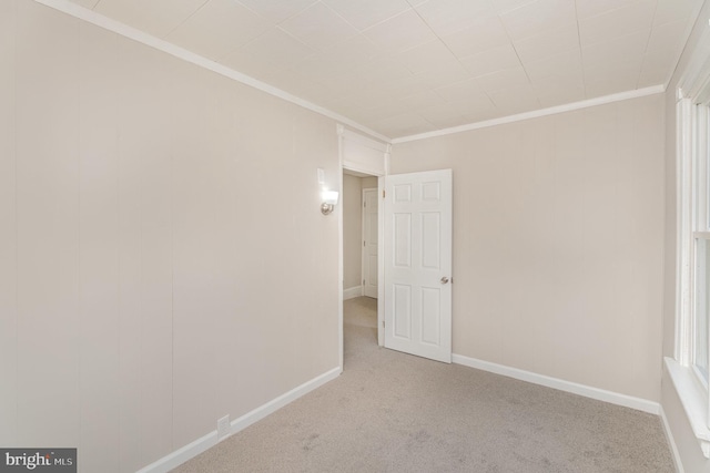 unfurnished room featuring crown molding and light colored carpet