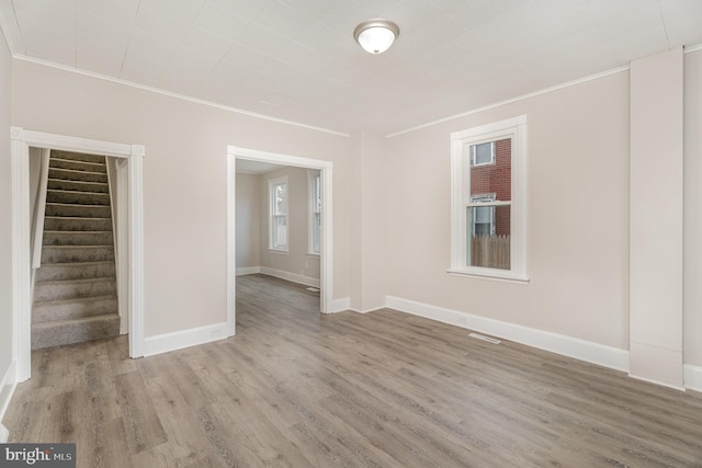 unfurnished room with crown molding and hardwood / wood-style flooring