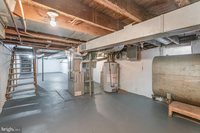 basement with heating unit, gas water heater, and electric panel