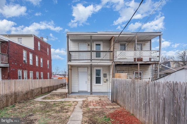 back of property with a balcony