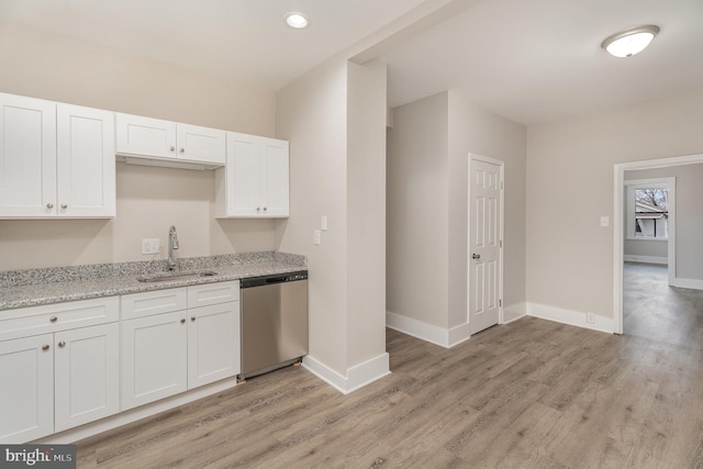 kitchen with white cabinetry, dishwasher, sink, and light hardwood / wood-style flooring