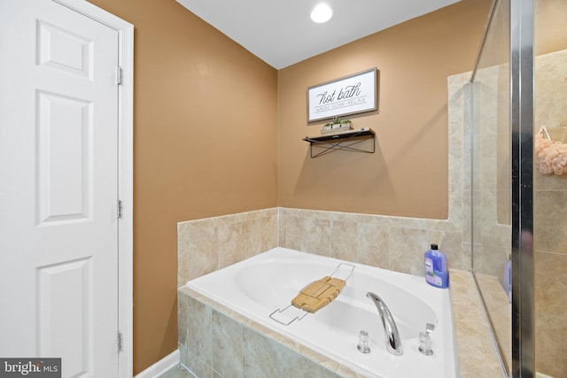 bathroom with tiled tub