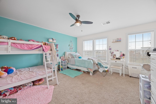 bedroom with carpet, radiator heating unit, and ceiling fan