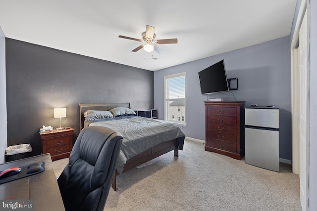 carpeted bedroom featuring stainless steel fridge and ceiling fan