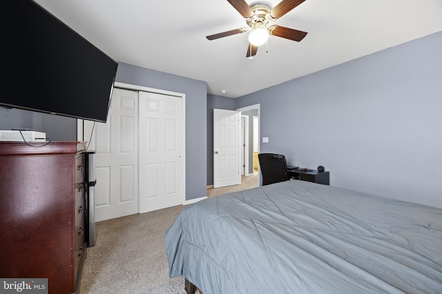 bedroom featuring ceiling fan, a closet, and light carpet