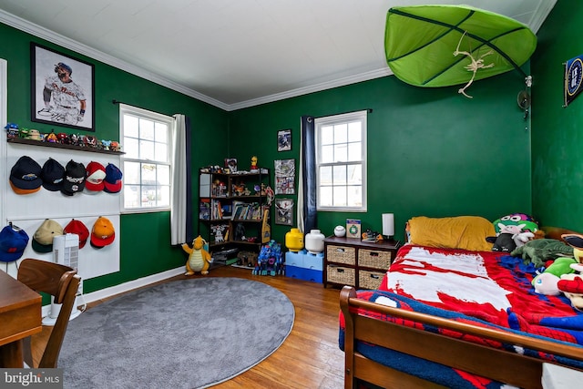 bedroom featuring multiple windows, ornamental molding, and hardwood / wood-style floors