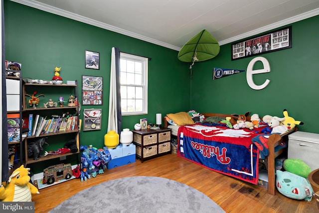 bedroom with ornamental molding and wood-type flooring