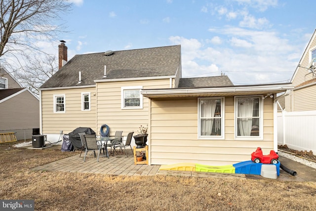 rear view of house with a patio and central AC