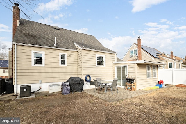 back of house featuring central AC, a patio area, and solar panels