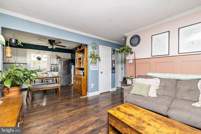 living room with dark hardwood / wood-style flooring, crown molding, and ceiling fan