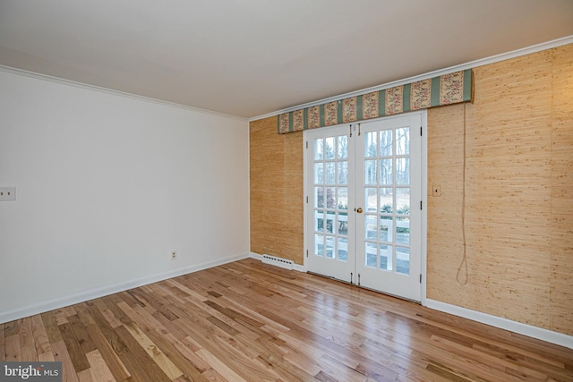 unfurnished room featuring french doors, visible vents, crown molding, and wood finished floors