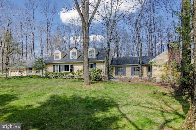 cape cod house with a chimney and a front lawn