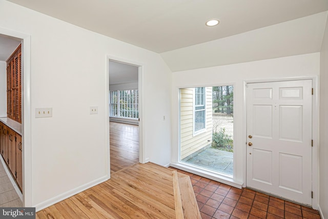 entrance foyer featuring recessed lighting, vaulted ceiling, baseboards, and wood finished floors