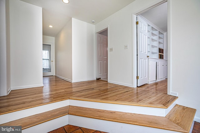 unfurnished room featuring recessed lighting, baseboards, and wood finished floors