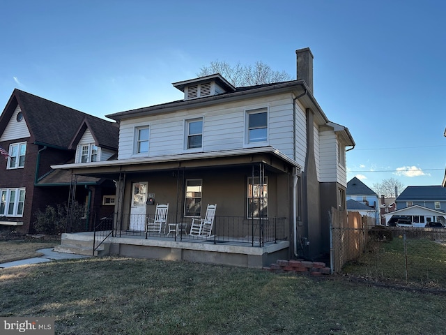 view of front of property with covered porch and a front yard