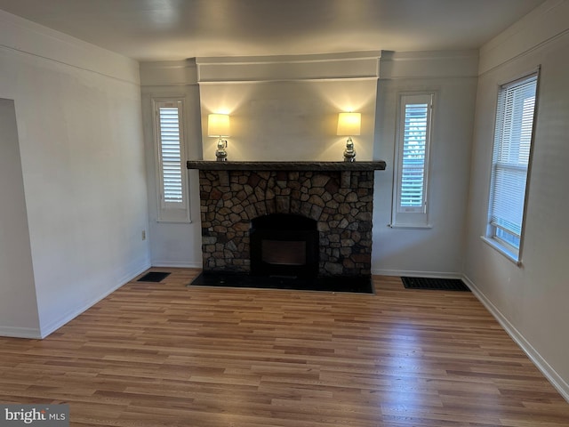 unfurnished living room with hardwood / wood-style flooring and a fireplace