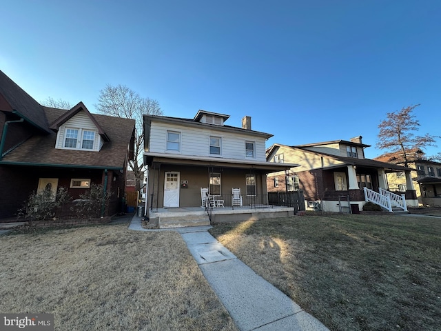 view of front of home featuring covered porch and a front lawn