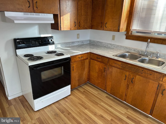 kitchen featuring sink, electric range, and light hardwood / wood-style floors