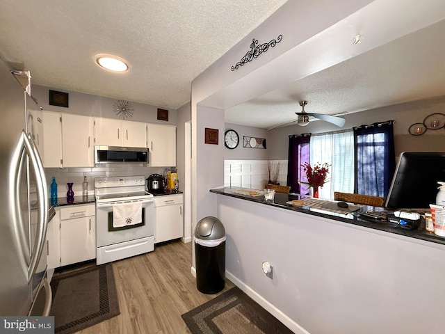 kitchen with light hardwood / wood-style flooring, backsplash, stainless steel appliances, a textured ceiling, and white cabinets