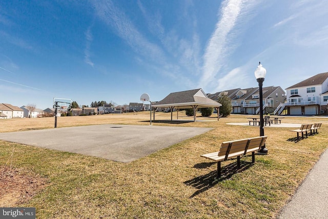 surrounding community featuring a gazebo, basketball hoop, and a lawn