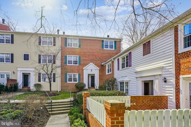 multi unit property with brick siding and fence