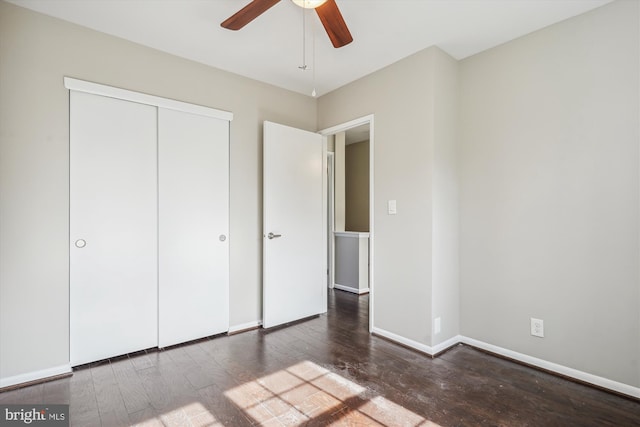 unfurnished bedroom with a closet, a ceiling fan, baseboards, and hardwood / wood-style flooring