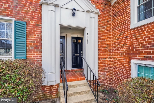 view of exterior entry with brick siding