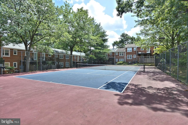 view of tennis court featuring fence