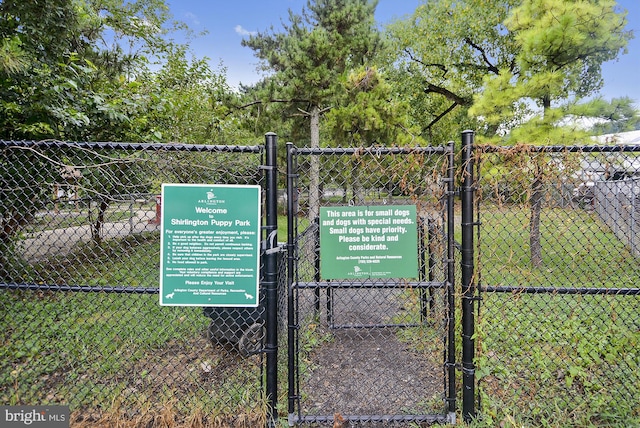 view of home's community with a gate and fence