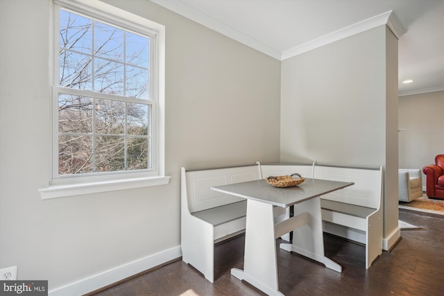 dining room featuring ornamental molding, wood finished floors, baseboards, and breakfast area