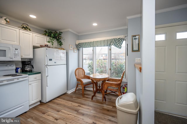 kitchen with white appliances, light hardwood / wood-style flooring, ornamental molding, and white cabinets