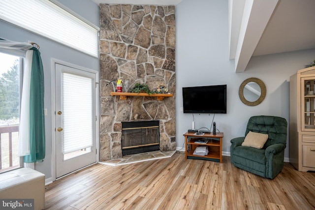 sitting room with a fireplace and light hardwood / wood-style floors