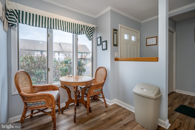 dining space with hardwood / wood-style flooring and ornamental molding