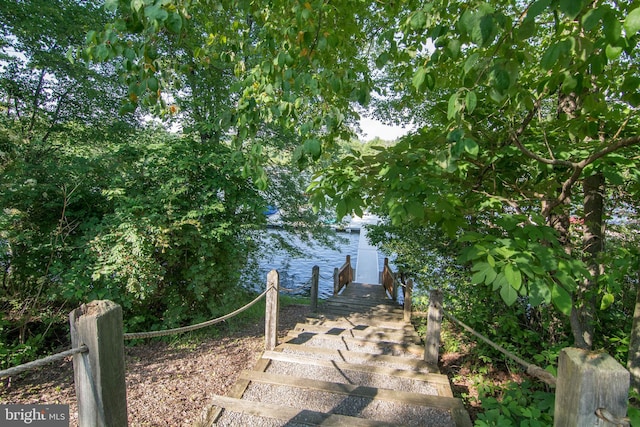 view of yard featuring a water view and a boat dock