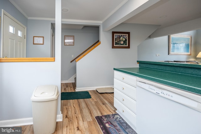 kitchen featuring white cabinets, ornamental molding, white dishwasher, and light wood-type flooring