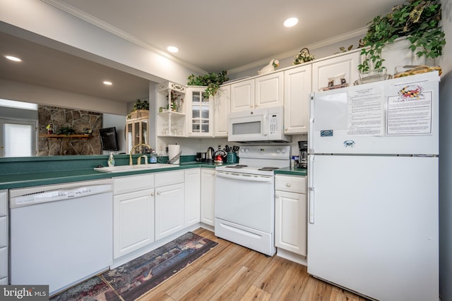 kitchen featuring white cabinetry, ornamental molding, sink, and white appliances